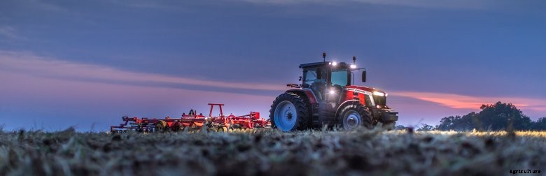 A Massey Ferguson works in the field in the dark to demonstrate the tractors lighting package
